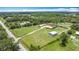 Expansive aerial view of a home with outbuildings, surrounded by lush greenery and open land at 4160 Packard Avenue, St Cloud, FL 34772