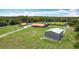 Wide aerial shot of the home, separate structure and spacious yard at 4160 Packard Avenue, St Cloud, FL 34772
