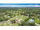 Wide aerial view showing the extensive acreage and surrounding lush greenery and other homes at 4160 Packard Avenue, St Cloud, FL 34772