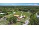 Aerial showcasing the house, long driveway and adjacent barn on a sprawling green lot at 4160 Packard Avenue, St Cloud, FL 34772