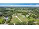 Stunning aerial view of a large lot with home, detached buildings and mature trees at 4160 Packard Avenue, St Cloud, FL 34772