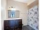 Bathroom vanity featuring mirror and cabinets, plus shower behind decorative curtain at 4160 Packard Avenue, St Cloud, FL 34772