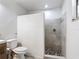 Bright bathroom featuring a stylish tiled shower with pebble floor, and a modern white toilet at 4160 Packard Avenue, St Cloud, FL 34772