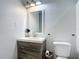 Neutral bathroom featuring a rustic-style vanity and a modern toilet at 4160 Packard Avenue, St Cloud, FL 34772
