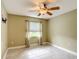 Bedroom with neutral walls, tile flooring, fan and a window with curtains at 4160 Packard Avenue, St Cloud, FL 34772