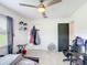 Bedroom with neutral walls, tile flooring, fan and gaming chair at 4160 Packard Avenue, St Cloud, FL 34772