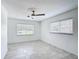 Bright, spacious bedroom featuring tile flooring, neutral walls, a fan and two windows at 4160 Packard Avenue, St Cloud, FL 34772