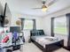 This cozy bedroom is decorated with a leather frame bed, dark curtains, and stylish decor at 4160 Packard Avenue, St Cloud, FL 34772