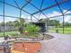 Enclosed patio featuring lush landscaping, a relaxing waterfall, and tranquil ambiance, creating a peaceful outdoor space at 4160 Packard Avenue, St Cloud, FL 34772