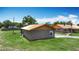 Single-story outbuilding with a metal roof and gray walls, located in a grassy lot at 4160 Packard Avenue, St Cloud, FL 34772