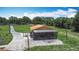 Charming exterior featuring a screened porch, basketball hoop, and spacious driveway, perfect for outdoor activities at 4160 Packard Avenue, St Cloud, FL 34772