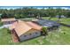 A high-angle shot showcases a home's exterior next to a spacious screened-in pool at 4160 Packard Avenue, St Cloud, FL 34772
