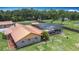 Aerial view showing pool in screened enclosure with a wide lawn and mature trees at 4160 Packard Avenue, St Cloud, FL 34772