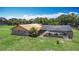 Aerial view of the home with screened in pool with lounge furniture and mature landscaping at 4160 Packard Avenue, St Cloud, FL 34772