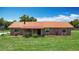Charming single-story brick home with a well-maintained lawn and metal roof at 4160 Packard Avenue, St Cloud, FL 34772