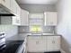 Bright kitchen with granite countertops, white cabinets and stainless steel appliances at 4160 Packard Avenue, St Cloud, FL 34772