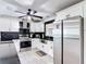 Kitchen features a stainless steel refrigerator and appliances, white cabinetry, and black tile backsplash at 4160 Packard Avenue, St Cloud, FL 34772