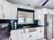 Modern kitchen featuring stainless steel appliances, a stainless steel sink, and white cabinetry at 4160 Packard Avenue, St Cloud, FL 34772