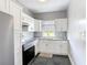 Bright kitchen with granite countertops, white cabinets and stainless steel appliances at 4160 Packard Avenue, St Cloud, FL 34772