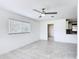 Bright living room featuring tile flooring, neutral walls, and a ceiling fan at 4160 Packard Avenue, St Cloud, FL 34772