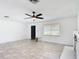 Bright living room features tile floors, ceiling fan and a decorative white fireplace at 4160 Packard Avenue, St Cloud, FL 34772
