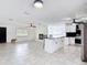 Open concept living space featuring a modern kitchen, fireplace, and tile flooring at 4160 Packard Avenue, St Cloud, FL 34772