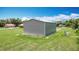 Outbuilding with roll-up door for storage and adjacent propane tanks at 4160 Packard Avenue, St Cloud, FL 34772
