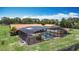 Home exterior showing screened-in pool, adjacent carport and spacious yard at 4160 Packard Avenue, St Cloud, FL 34772