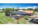 Aerial view of screened-in pool with poolside seating and lush landscaping at 4160 Packard Avenue, St Cloud, FL 34772