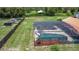 Screened-in pool includes water slide, patio seating and beautiful landscape at 4160 Packard Avenue, St Cloud, FL 34772