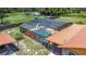 Overhead angle of in-ground pool surrounded by screened-in enclosure and yard at 4160 Packard Avenue, St Cloud, FL 34772