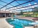 Sparkling screened in pool with slide, and tropical landscaping at 4160 Packard Avenue, St Cloud, FL 34772