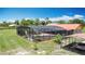 A screened-in pool in a lush backyard features mature landscaping and an attached carport at 4160 Packard Avenue, St Cloud, FL 34772