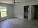 This bedroom features luxury vinyl plank flooring, a ceiling fan, and an attached bathroom at 4325 Sw 157Th Ter, Ocala, FL 34481
