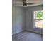This bedroom features luxury vinyl plank flooring, a ceiling fan, and backyard views at 4325 Sw 157Th Ter, Ocala, FL 34481