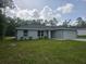 Charming single-story home with green grass, tasteful landscaping, and a paved driveway at 4325 Sw 157Th Ter, Ocala, FL 34481
