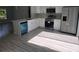 Modern kitchen features white cabinets, stainless steel appliances, a blue dishwasher, and stylish flooring at 4325 Sw 157Th Ter, Ocala, FL 34481