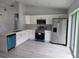 Modern kitchen with white cabinets, stainless steel appliances, quartz countertops and luxury vinyl floors at 4325 Sw 157Th Ter, Ocala, FL 34481