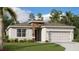 Charming single-story home featuring a stone accent wall and a well-manicured lawn surrounded by mature trees at 4741 Katrina Dr, Haines City, FL 33844