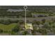An aerial view showcases a well-maintained home with a lush green lawn, nestled in a peaceful neighborhood with mature trees at 4865 Gorham Ave, Orlando, FL 32817