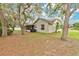 Charming home featuring a screened lanai and a spacious backyard shaded by mature trees at 4865 Gorham Ave, Orlando, FL 32817