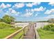 Picturesque lake view with a wooden fishing dock and surrounding lush greenery at 4865 Gorham Ave, Orlando, FL 32817