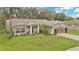 Charming single-story home with well-manicured lawn, mature trees, and welcoming front entrance, complete with a two-car garage at 4865 Gorham Ave, Orlando, FL 32817