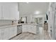 Modern kitchen with stainless steel appliances, a corner sink with white cabinetry, and seamless access to the dining area via an archway at 4865 Gorham Ave, Orlando, FL 32817
