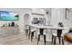 Open concept kitchen features a breakfast bar with stylish seating, stainless steel appliances, and seamless flow to the dining area at 4865 Gorham Ave, Orlando, FL 32817