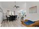 Bright living area with modern ceiling fan, dining table, wood-look floors, and sliding doors to the outdoors, perfect for entertaining at 4865 Gorham Ave, Orlando, FL 32817
