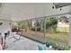 Enclosed patio, perfect for enjoying the outdoors, features a hammock and views of the lush backyard at 4865 Gorham Ave, Orlando, FL 32817