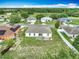 Aerial view of the home's backyard, patio, and the surrounding neighborhood at 5125 Pine Needle Dr, Mascotte, FL 34753