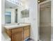 Secondary bathroom featuring a single sink vanity, and a walk-in shower with glass doors at 5125 Pine Needle Dr, Mascotte, FL 34753