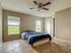 Bedroom featuring tile floors, two windows, a ceiling fan, and a closet at 5125 Pine Needle Dr, Mascotte, FL 34753